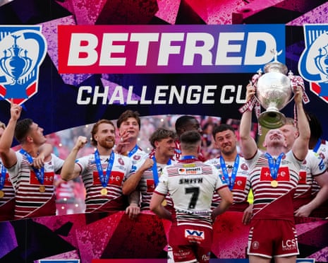 Liam Farrell lifts the Challenge Cup after Wigan’s emphatic victory