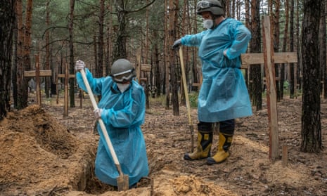 Men in plastic suits and spades digging into grave.