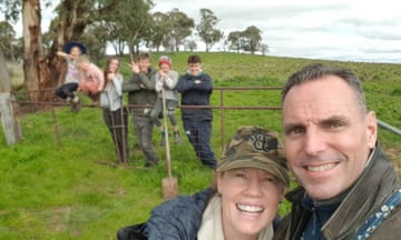 A selfie of the Duggans with their kids in the background on a rural property