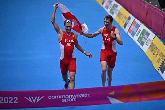 Dave Ellis celebrates with his guide Luke Pollard as he crosses the line to take gold in the men’s para triathlon.