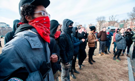 Antifa members form a circle and surround helmeted members of a rightwing and pro-Trump group during the 2019 Women’s March at Boston Common in Boston, Massachusetts, on 19 January.