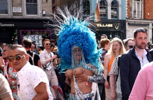 A parader in costume passes through Soho