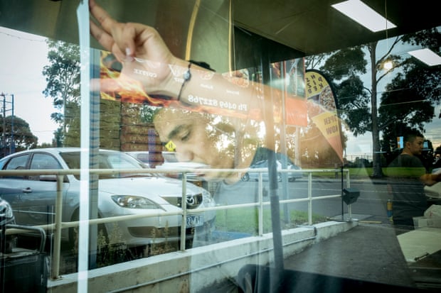 Noor measures up a window in a kebab shop for a promotional poster promoting Noor and Masuma’s bolani pastry pockets