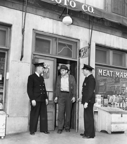 three men stand outside a store