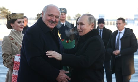 Alexander Lukashenko, left, greets Vladimir Putin as he arrives in Minsk for talks in December