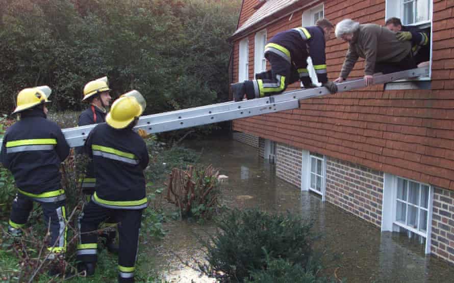 Fire officers rescue a woman after the River Ouse flooded Lewes, East Sussex, in October 2000.