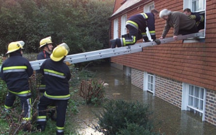 Fire officers rescue a woman after the River Ouse flooded Lewes, East Sussex, in October 2000.
