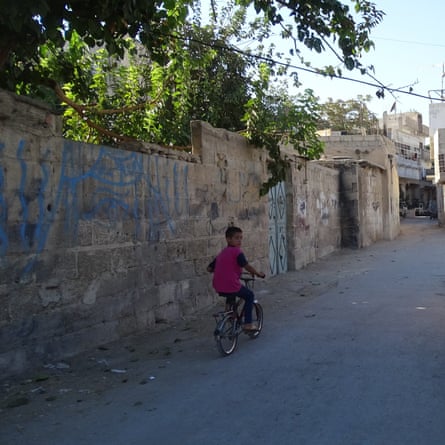 A child rides a bike in Qaboun when it was a busy working-class suburb of Damascus