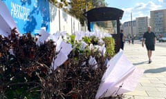 A pedestrian walks past paper planes displayed as a reference to the Telegram logo outside France's embassy in central Moscow.