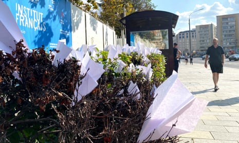 A pedestrian walks past paper planes displayed as a reference to the Telegram logo outside France's embassy in central Moscow.