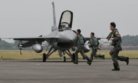 Taiwan air force pilots run toward F-16V fighter jets during a military drill.
