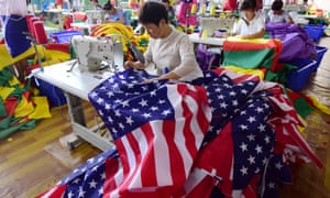 A woman sews American flags in a Chinese factory