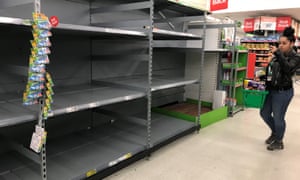 Empty shelves where toilet roll is usually stocked in an Asda store in Clapham Junction, London.