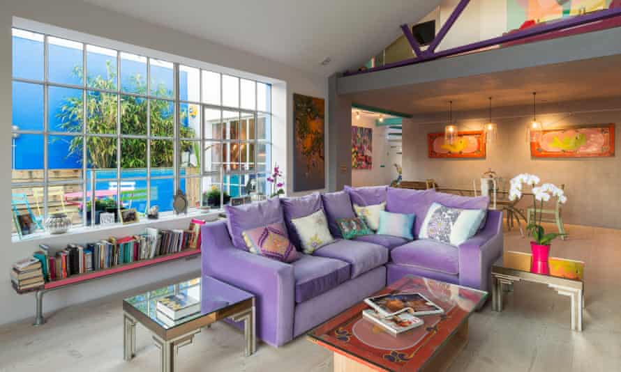 ‘Bright colours have become normal to me now. It’s what I know’: the living room with vibrant purple sofa.