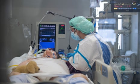 A healthcare worker tends to a Covid-19 patient at an Intensive Care Unit (ICU) in Barcelona.