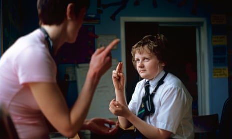 Teacher with deaf pupil in classroom