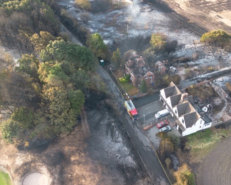 An aerial view shows burnt houses as the wildfire continues to spread to the golf course in Stourbridge, England.
