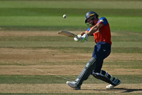Jos Buttler hits a six to bring up his century.
