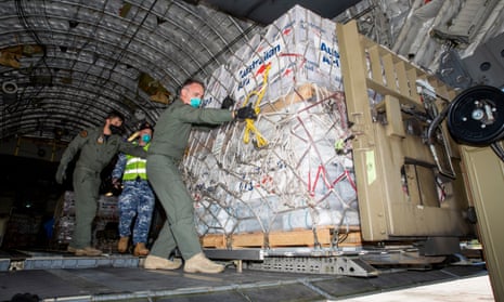 Members of the Australian defence force unload aid supplies at Tonga’s Fuaʻamotu international airport.