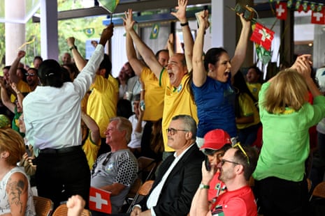 Fans of Brazil and Switzerland react while watching the live broadcast of the Qatar 2022 World Cup Group G football match between Brazil and Switzerland at the Swiss Embassy in Brasilia.