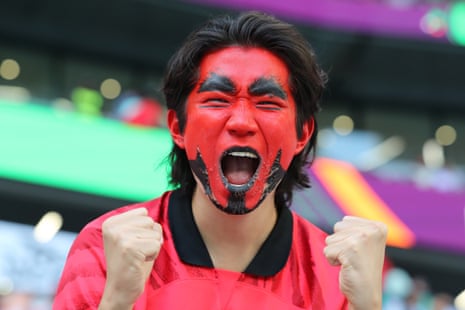 A South Korea fan gets himself wound-up ahead of kick-off. 