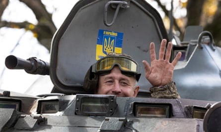A Ukrainian soldier waves from an armoured personnel carrier outside Kramatorsk.