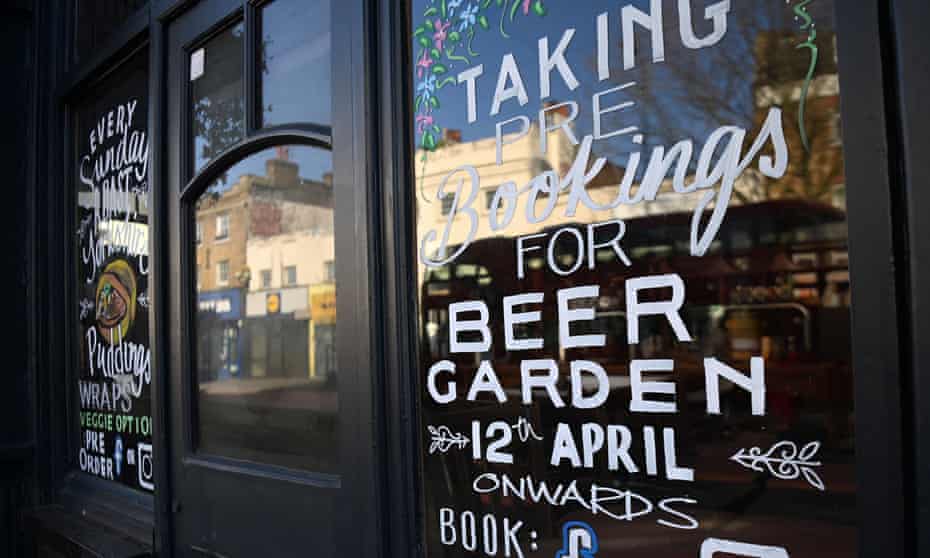 A pub sign promotes its reopening in London