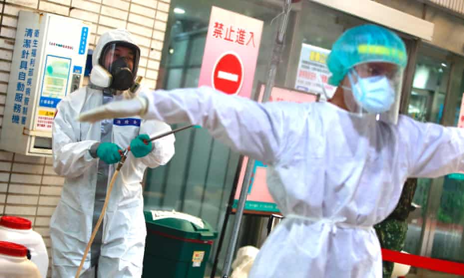 Military officers disinfect medical workers at a rapid Covid testing centre, as Taiwan adds 333 domestic cases and 2 imported cases, a record high number that jumps from Sunday’s figure.