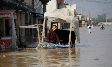 A boy at a former street stall in a flooded area of Khyber Pakhtunkhwa province, Pakistan, in August.