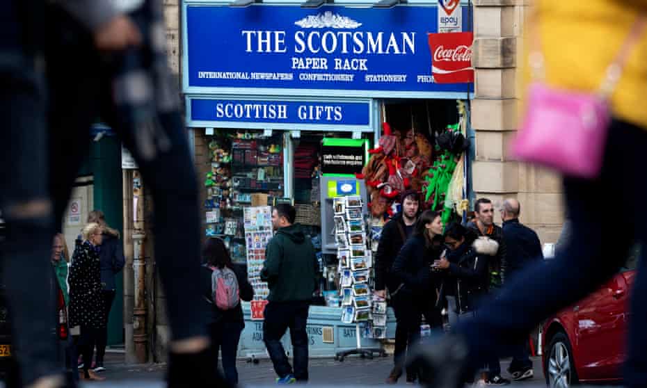 A sign showing The Scotsman masthead above a shop in Edinburgh. 