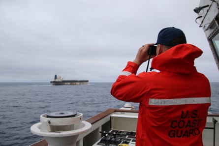 A member of the US Coast Guard observing a Venezuela-linked oil tanker.