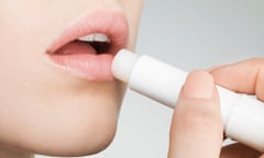 Female applying lip balm, close up, side view<br>GettyImages-478538759