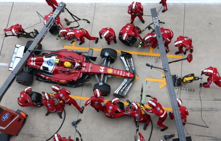 Lewis Hamilton’s Ferrari is serviced by the pit crew during the China GP