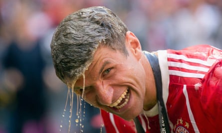 Thomas Müller is able to smile despite having just been showered in beer as Bayern celebrated their 67th German league title.