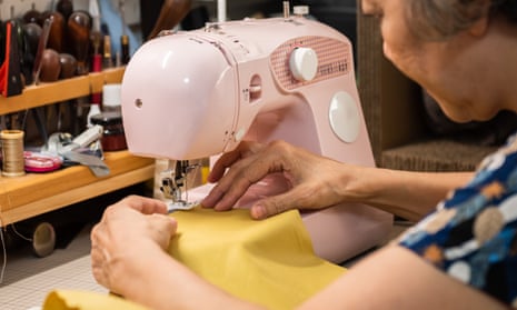 Senior woman sewing on a sewing machine