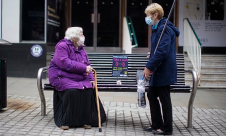 two women in face masks talking in Rochdale town centre