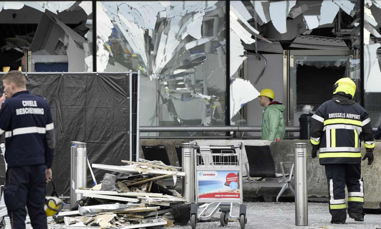 Rescue workers outside the damaged front of Brussels airport.