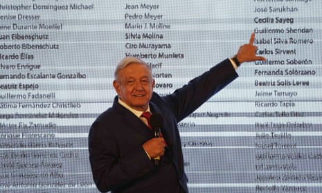 President Andrés Manuel López Obrador points to the name of journalist Guillermo Sheridan as he stands in front of a list of names he said belonged to people who affirm that he lost the 2006 election that he claims was stolen, in Mexico City in November