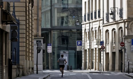 A man runs in an empty street in Paris