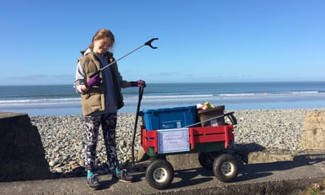Skye Neville at the beach with a trolley and a litter-picking tool