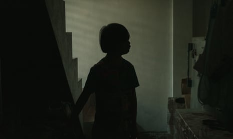 silhouette of a boy standing by some stairs