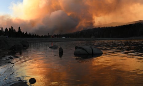 The Caldor fire is reflected off of Caples Lake near Kirkwood ski resort on Wednesday.
