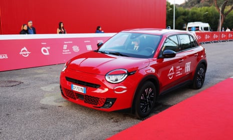 Shiny, liveried red car parked