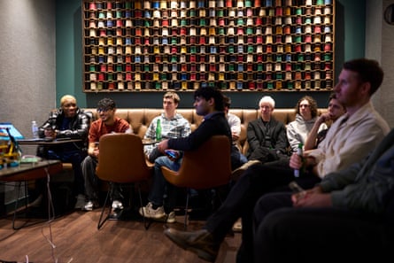 Men sitting on sofas and chairs at a gathering