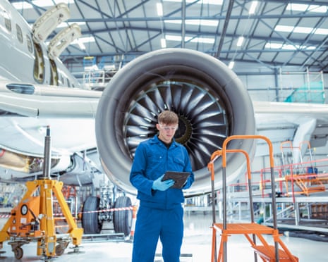 Apprentice aircraft maintenance engineer in maintenance hangar