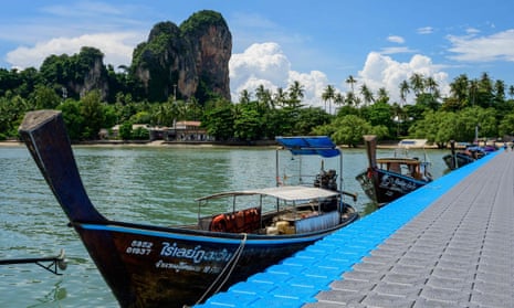 Longtail boats wait at the pier on East Railay Beach in Krabi as the country prepares to welcome back visitors.