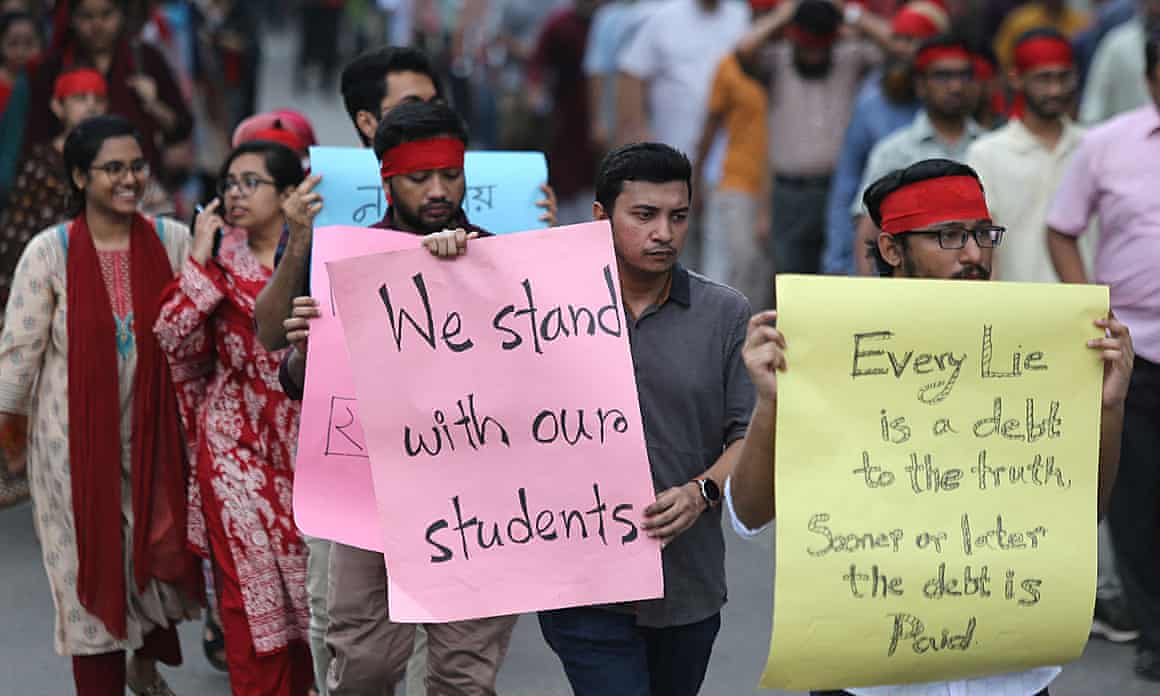 People holding placards supporting students