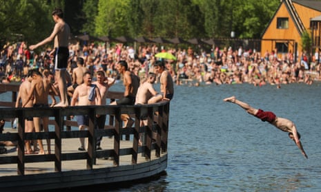 People cool off in Meshchersky pond in Moscow as temperatures soared.
