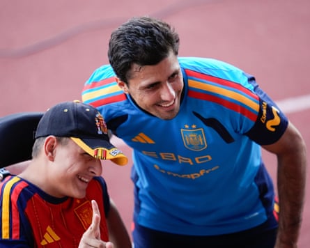 The Spain menâÂÂs football captain, Rodri, poses for a photo with a fan during a training session.