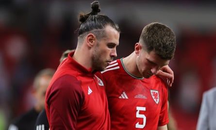 Gareth Bale (left) of Wales and teammate Chris Mepham react after their World Cup campaign comes to an early end.